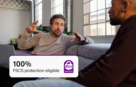Two people talking business while seated on a sofa, with a FCSC card overlayed on top of the image