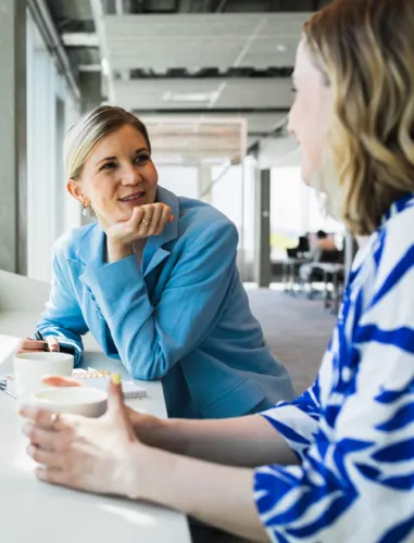 Two woman talking and enjoying a coffee