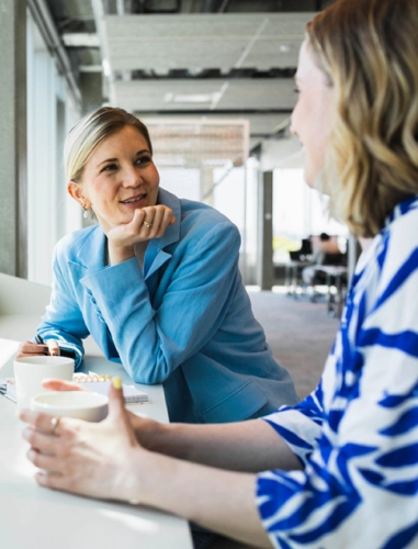 Two woman talking and enjoying a coffee